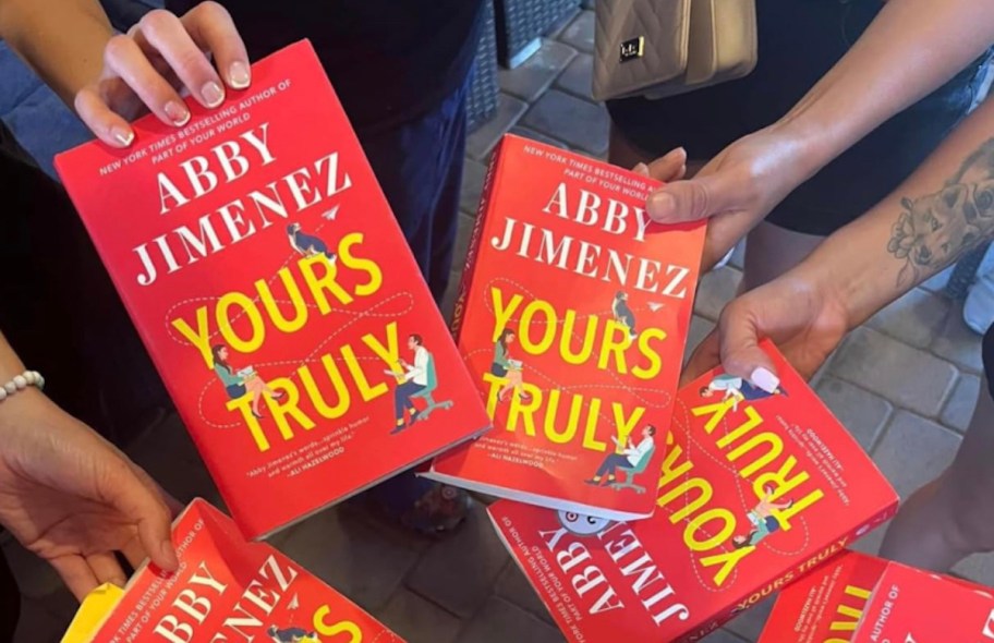 hands holding copies of yours truly books