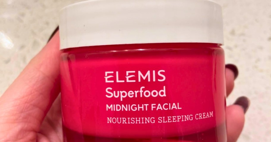 hand holding a container of ELEMIS Superfood Midnight Facial