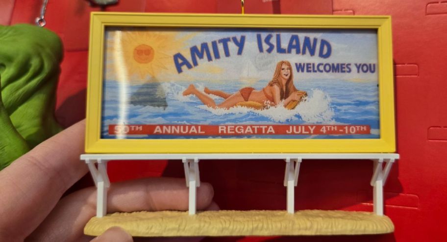hand holding 2025 amity island ornaments