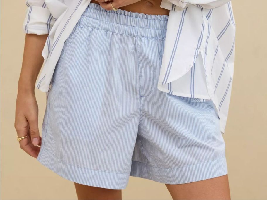 A woman wearing a pair of white striped shorts