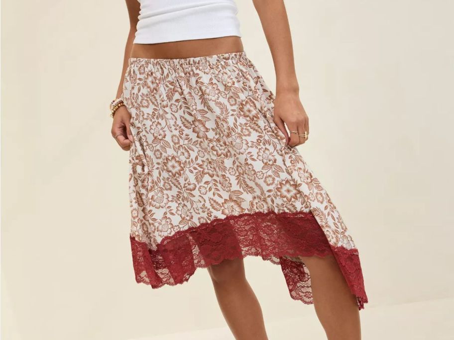 A woman wearing a red and white asymmetrical skirt 