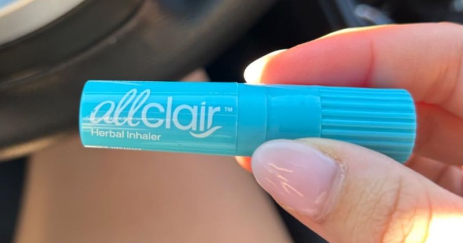 Hand holding an Allclair stick