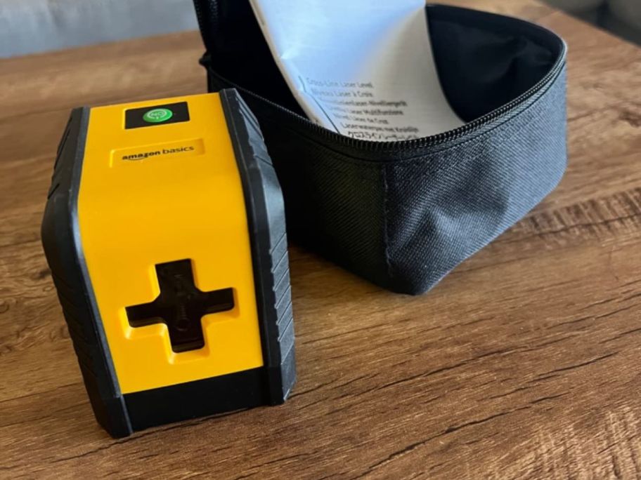 A yellow laser level with a case