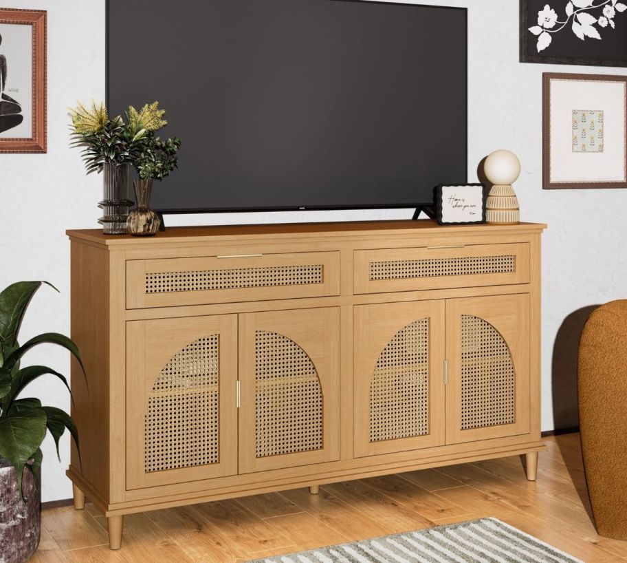 a rattan tv stand in honey colored wood