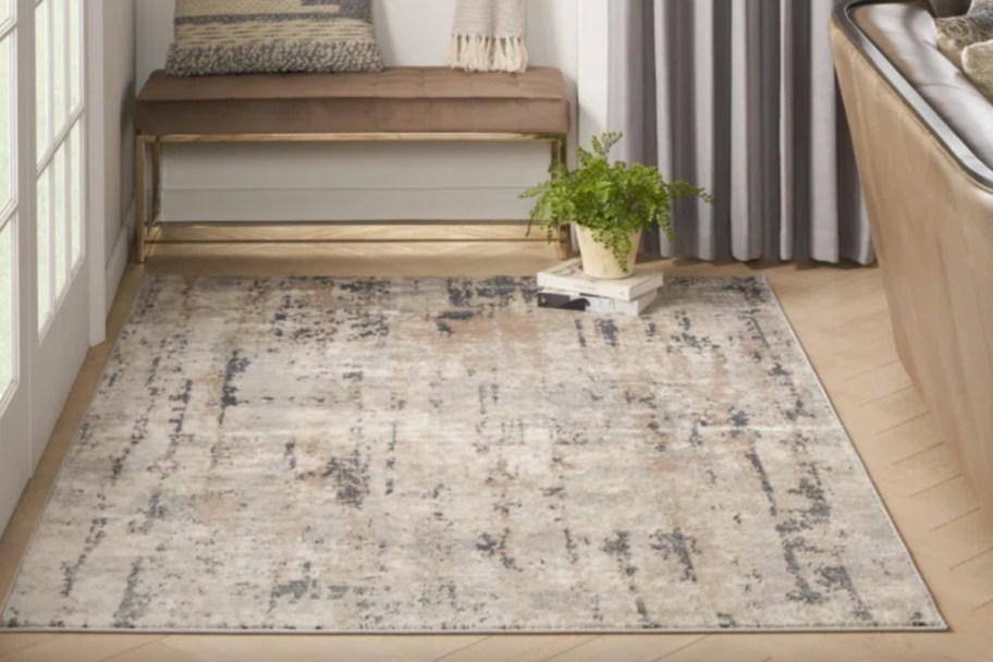 abstract area rug in entry way near show bench