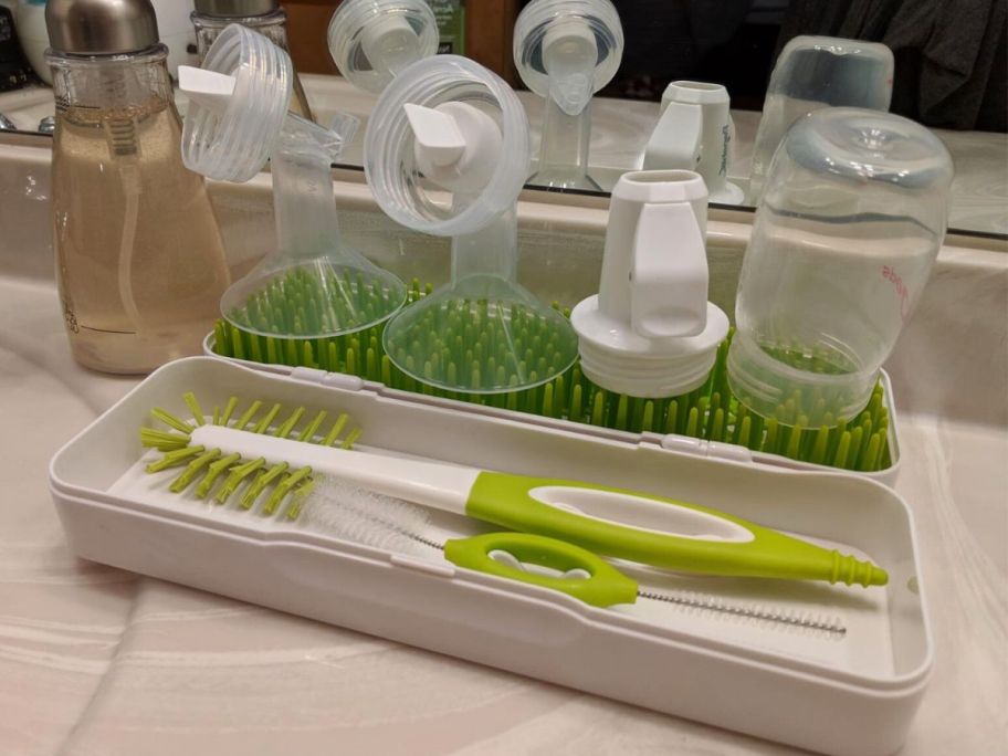 A Boon Trip Portable Silicone Bottle Drying Rack with pump parts drying on it