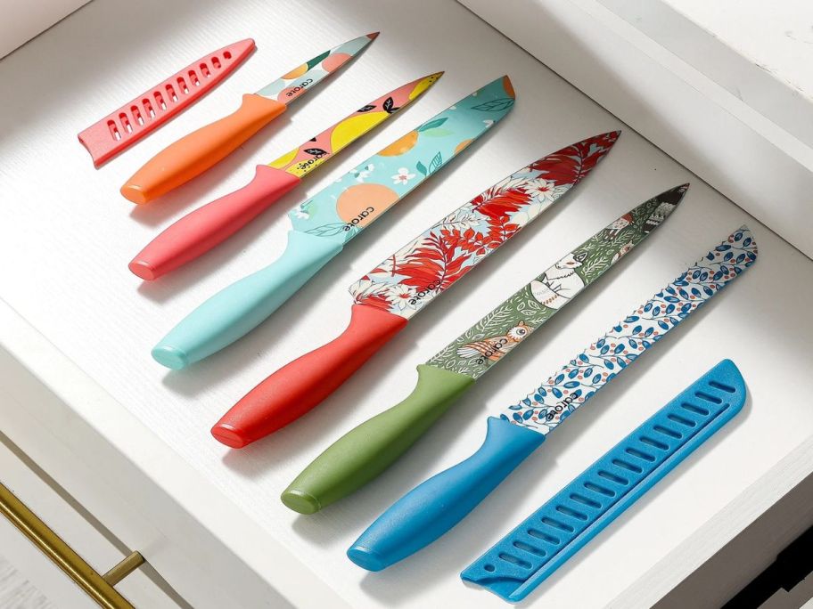 A drawer with several Carote ceramic coated knives and blade guards in it