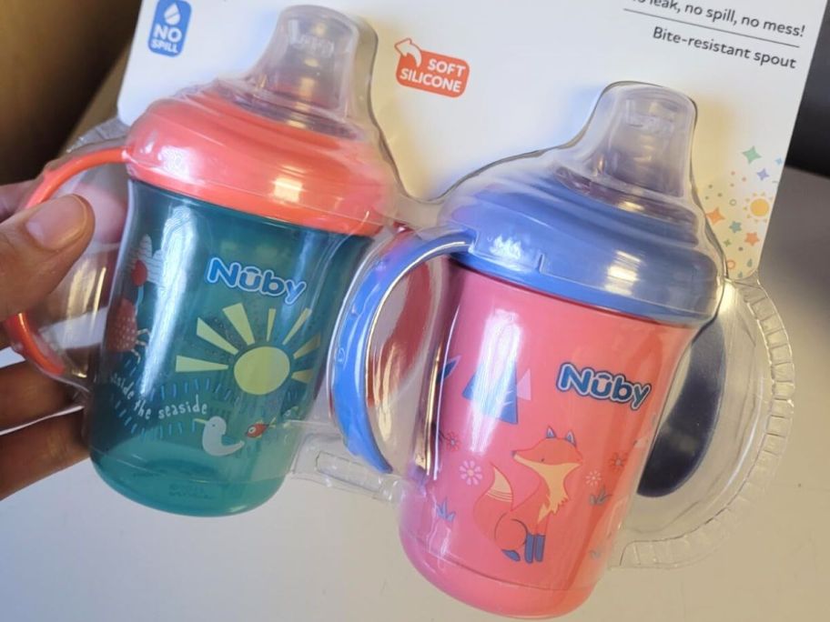 Hand holding a pack of Nuby Baby’s First Soft Spout Cups