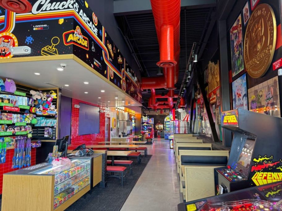 A picture of an arcade with tables and prizes