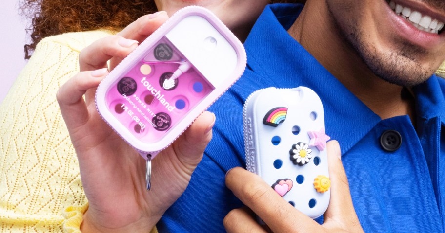 woman and man holding up Crocs Touchland cases