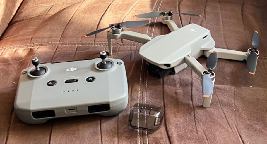 DJI Mini 4K Drone with its remote on the the car seat