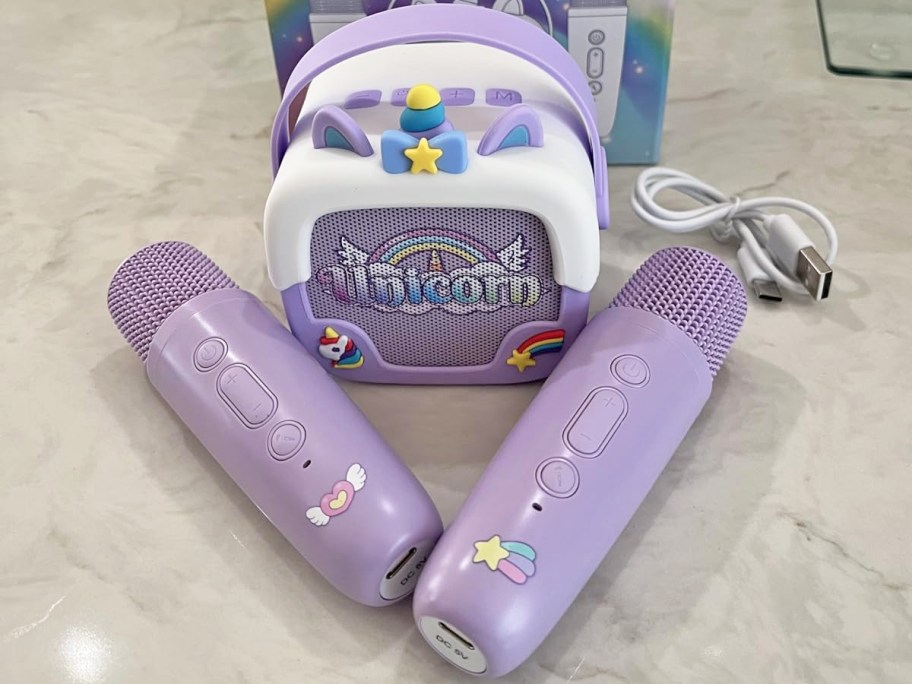 purple and white unicorn print Mini Karaoke Machine with two purple microphones
