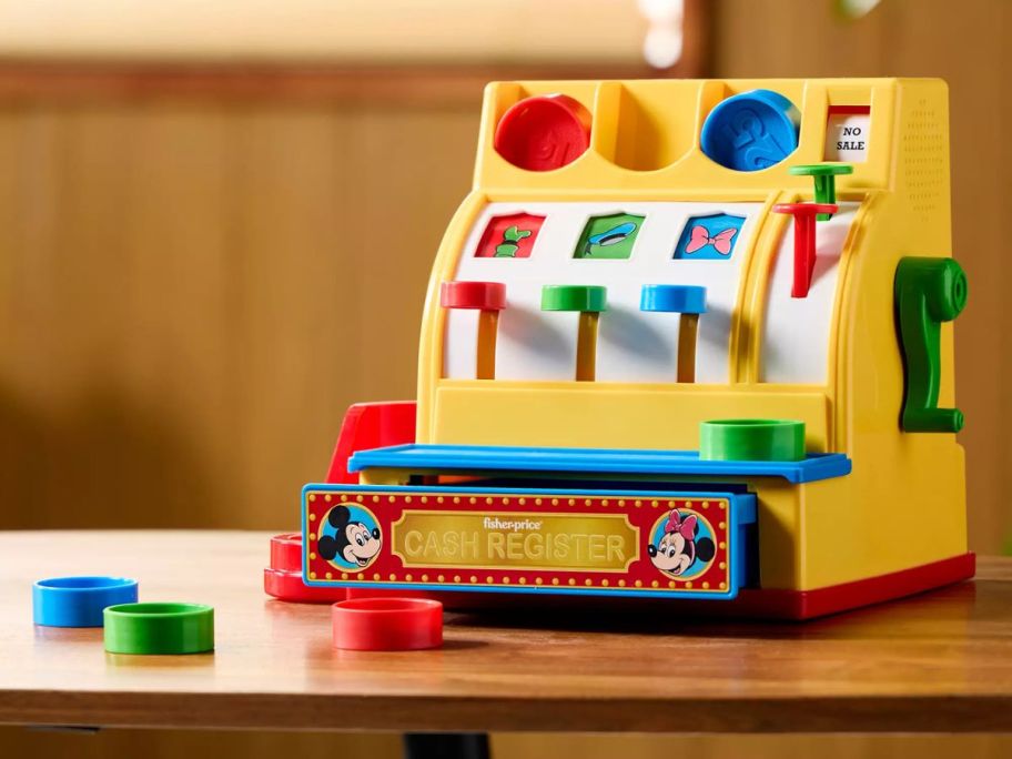 A plastic yellow kid's toy cash register