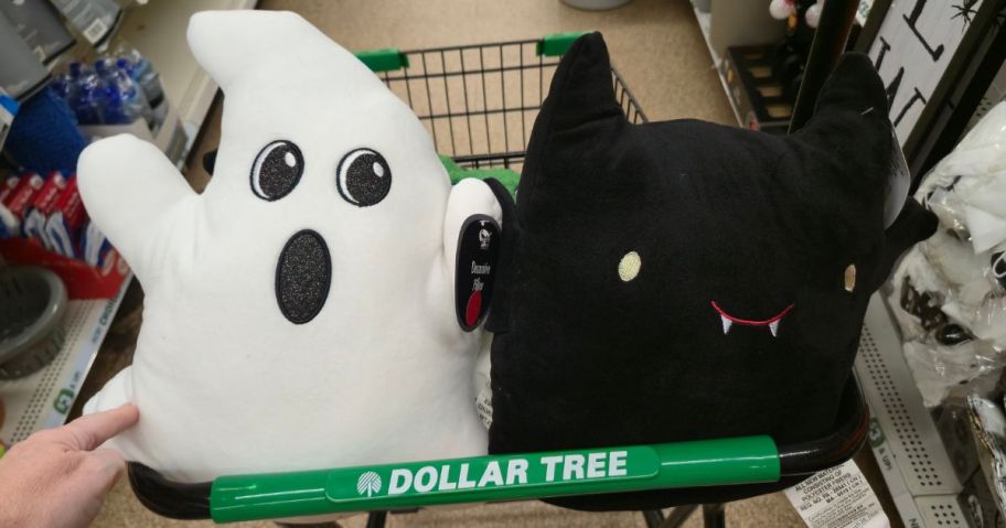 Two Dollar Tree Throw Pillows shaped like a ghost and bat in dollar tree cart