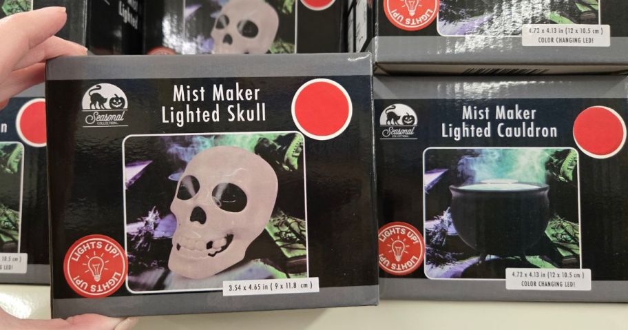 A shelf with Halloween LED Witch Cauldrons & Skulls w/ Fog at Dollar Tree