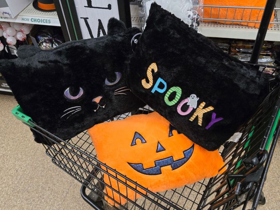 A cart full of Dollar Treen Halloween throw pillows