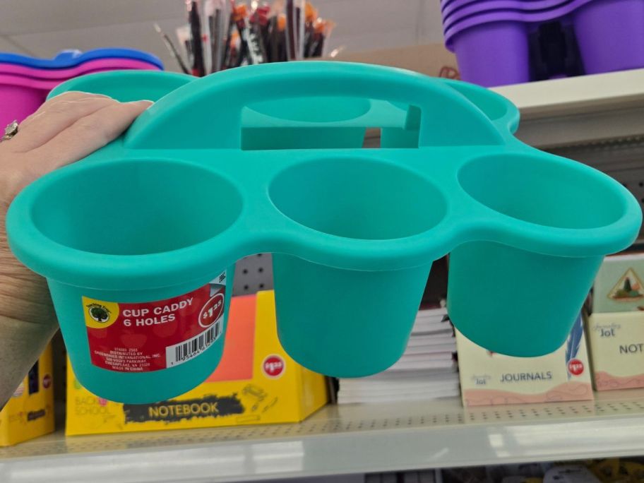 Hand holding a Teaching Tree 6-Hole Cup Caddy