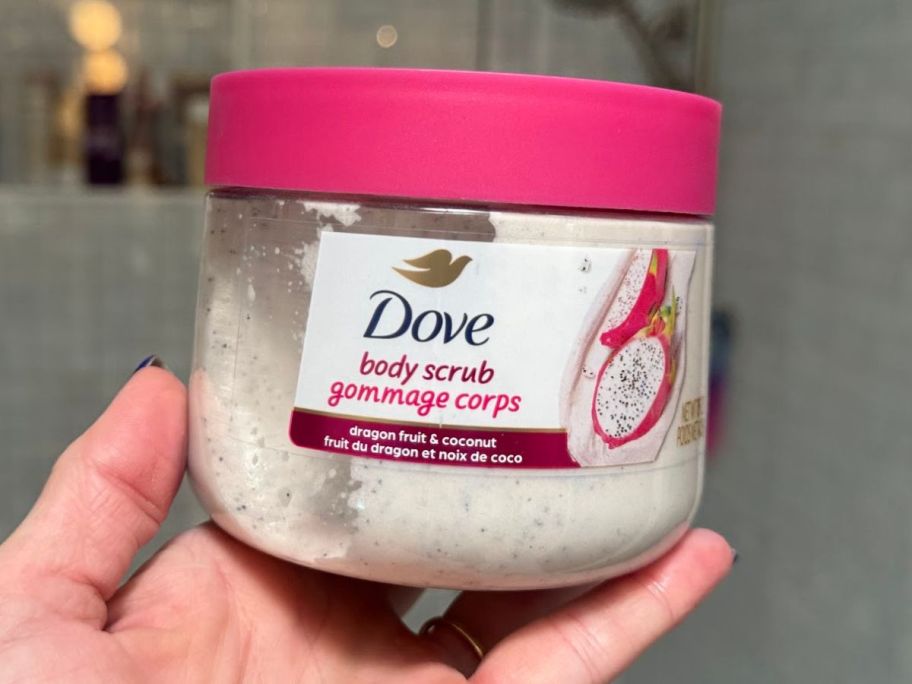 hand holding dove body scrub in the bathroom