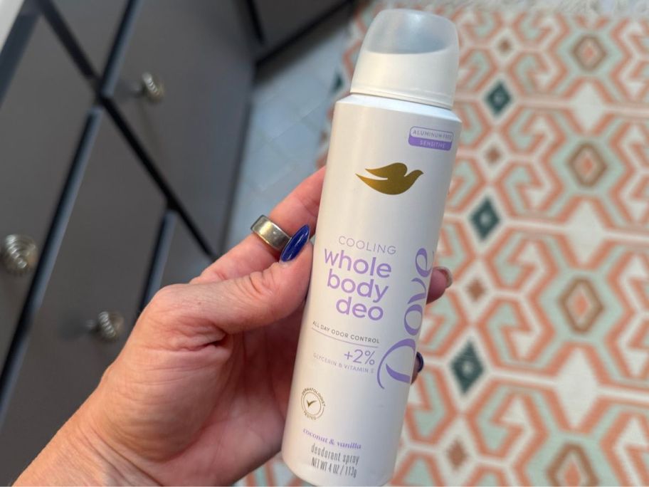 hand holding Dove Whole Body Deo Aluminum Free Invisible Spray Deodorant - Coconut & Vanilla