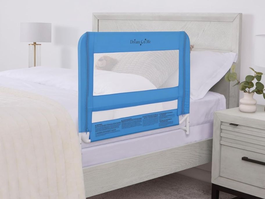 A bed with a Dream on Me Bedrail