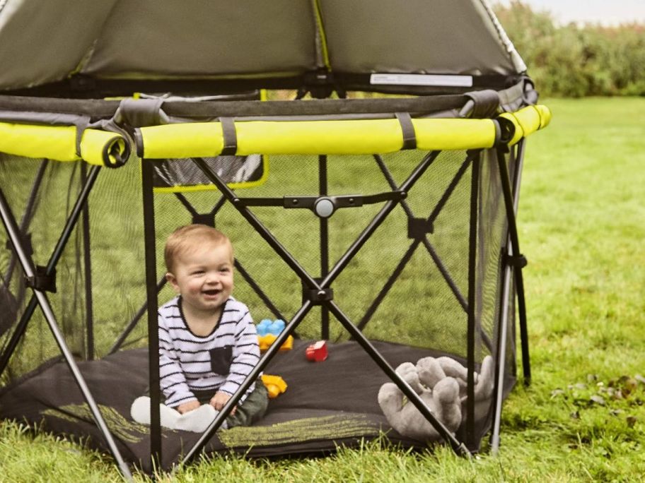 A baby inside of a Evenflo Play-Away Portable Playard Deluxe 