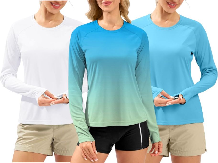 3 women wearing long-sleeved rash guards