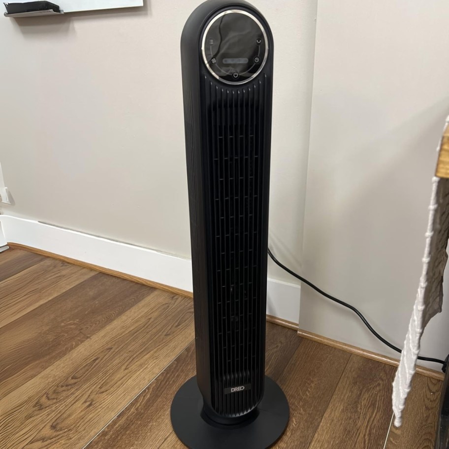 a black tower fan in a living room