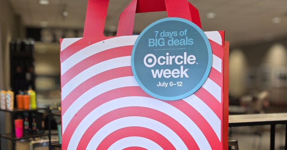a large red and white sign shaped like a Target bag with a sign that says 7 Days of Deals - Target Circle Week on it