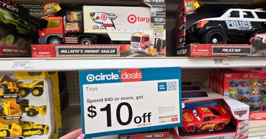 toy cars and trucks on a Target shelf with a sign that says $10 off a $40 purchase