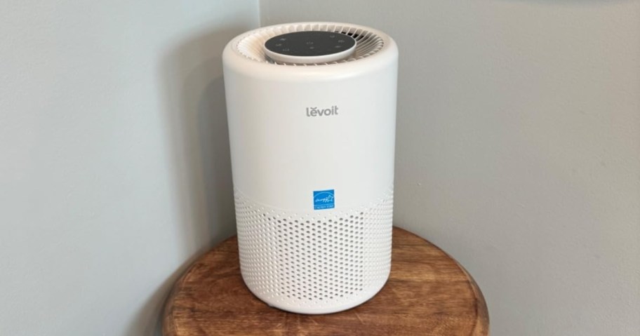 a small white air purifier on a side table