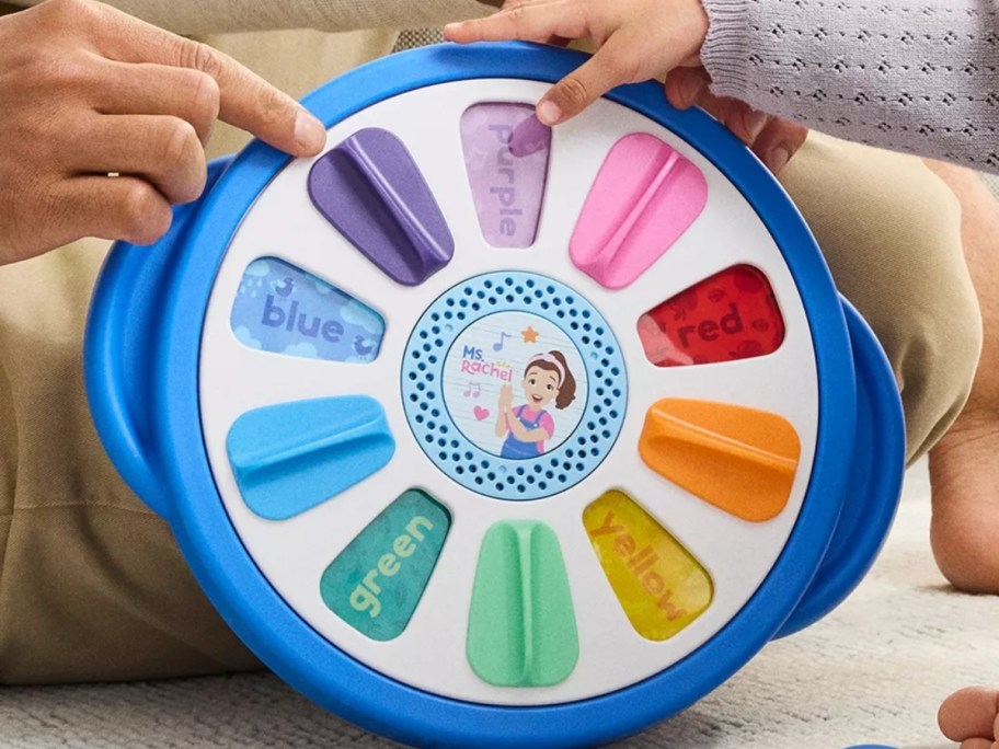 girl playing with a Ms. Rachel learning wheel toy