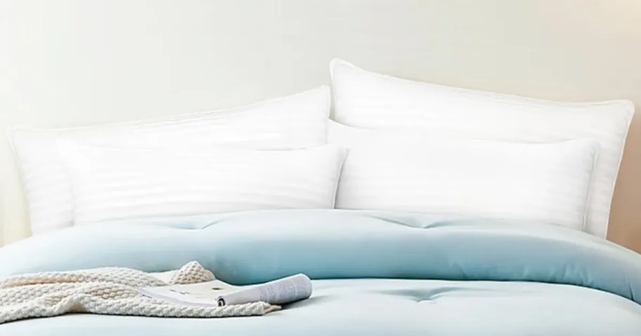 bed made with pillows on top