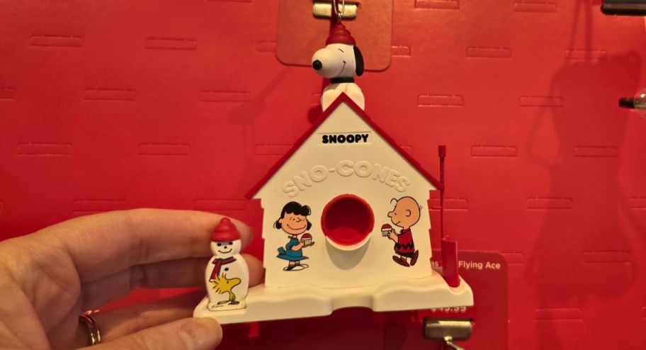 hand holding Hallmark Keepsake The Peanuts Gang 75th Anniversary Sno-Cones w Friends Ornament