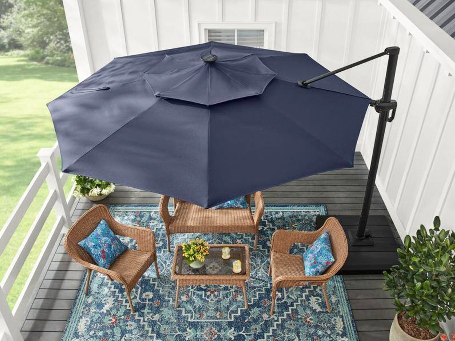large blue umbrella hanging over a patio set