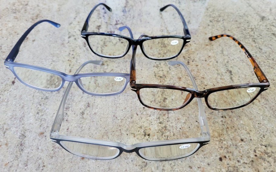 4 pairs of reading glasses on a counter