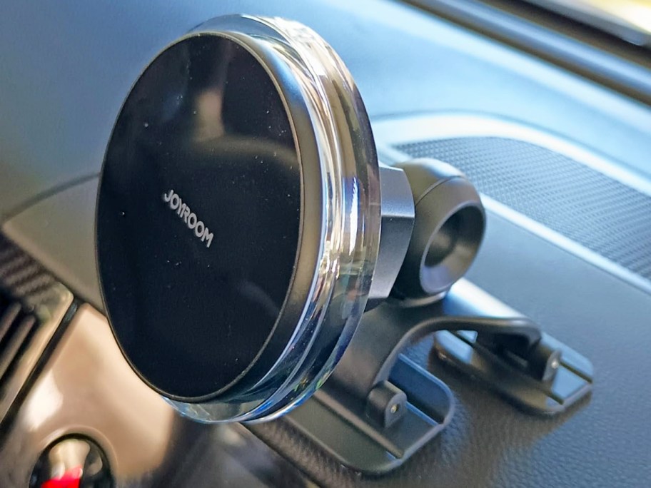 round black phone mount stuck to car dashboard