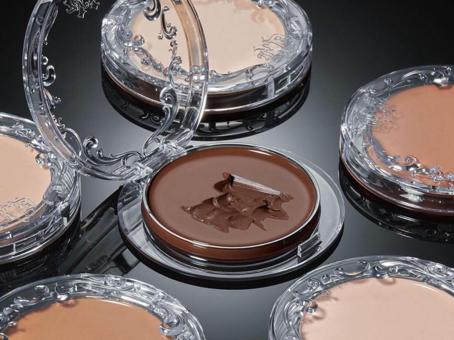 Compacts of KVD Beauty Good Apple Lightweight Full-Coverage Cream Foundation Balms in various shades