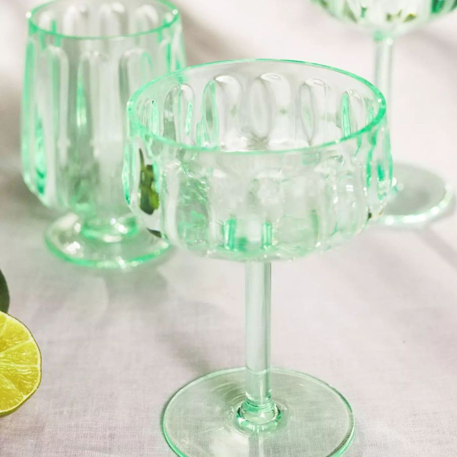 Lucia Acrylic Wine Glasses Set of 4 in green on top of a table