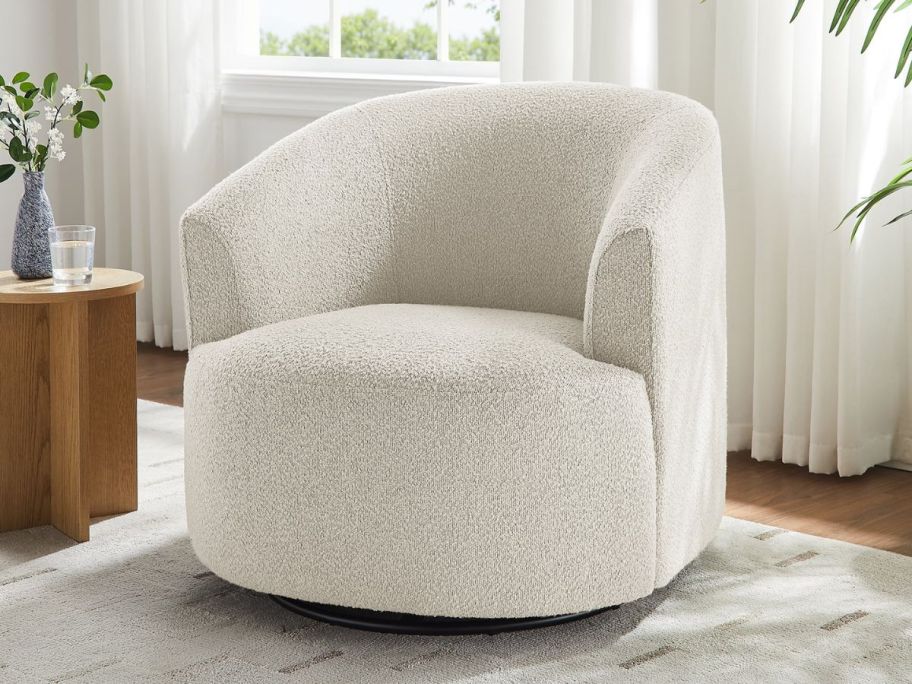 A white swivel chair in a living room