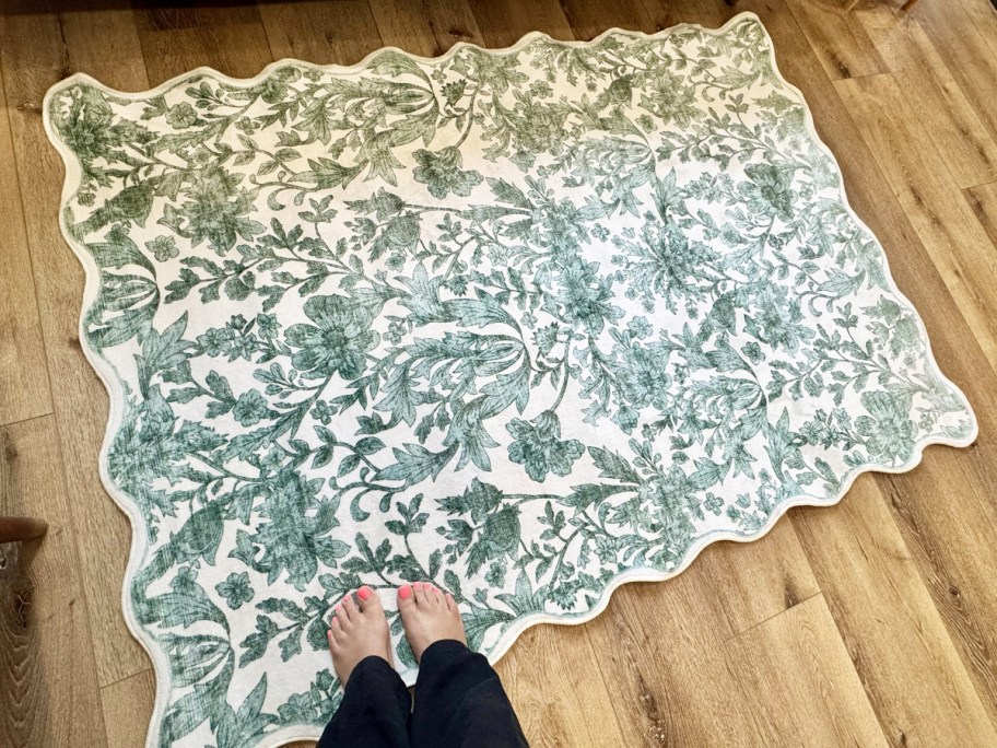 woman's feet on a blue and white scalloped edge area rug