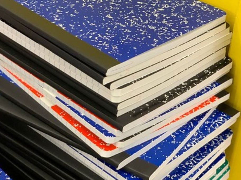 A stack of composition books in different colors