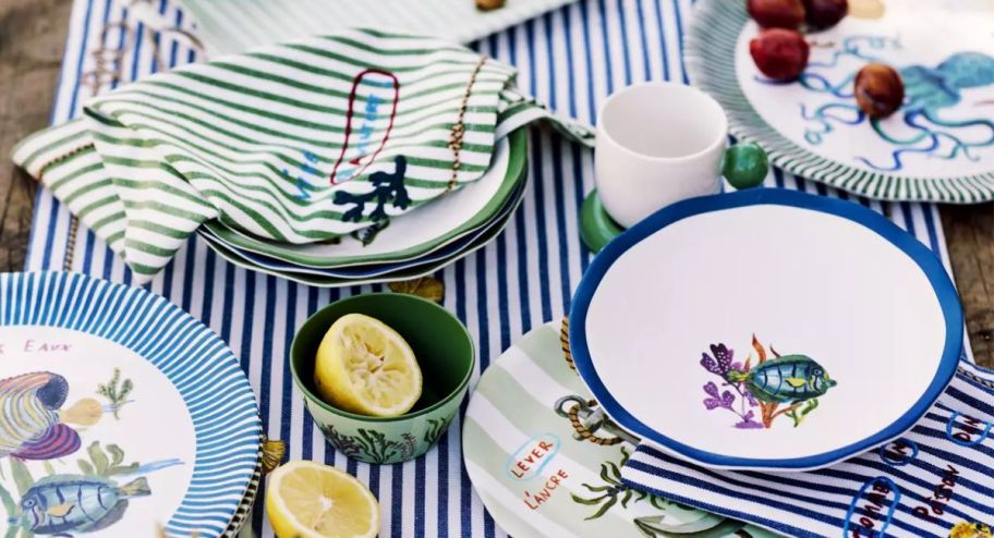 stripped napkins displayed on the table with plates and fruits