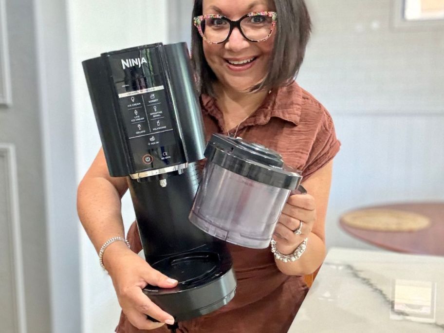 woman holding the ninja cream machine and pint 