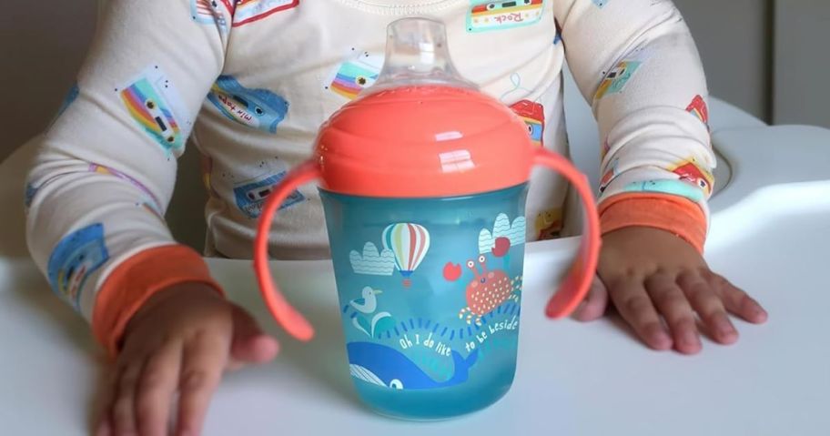 Toddler boy with a Nuby Sippy Cup