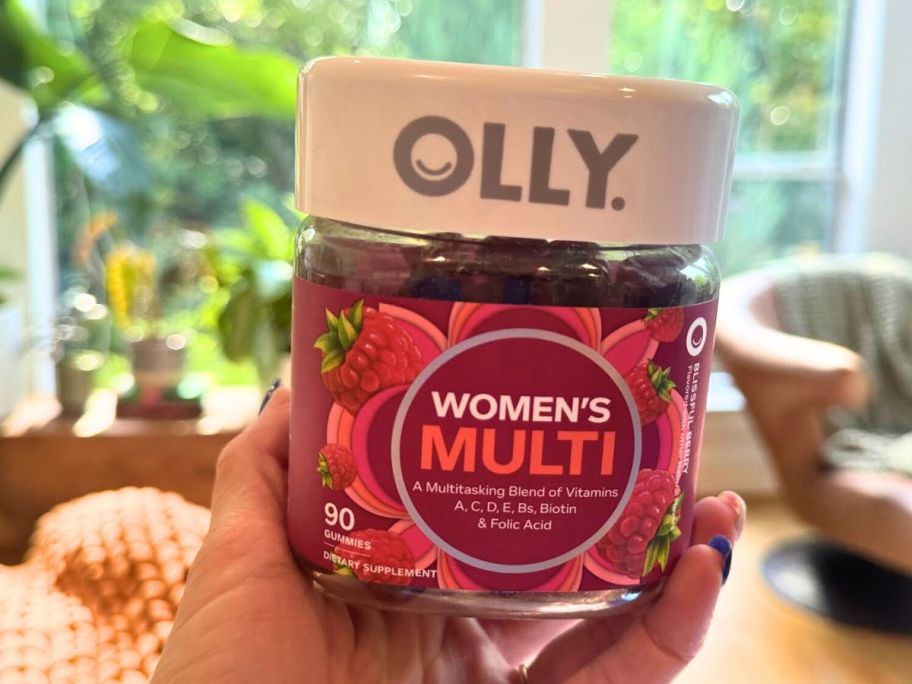 woman holding up OLLY Women's Multivitamin Gummy 90-count