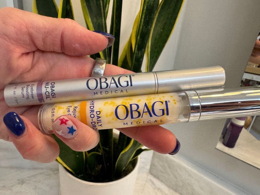 hand holding two different obagi serums 