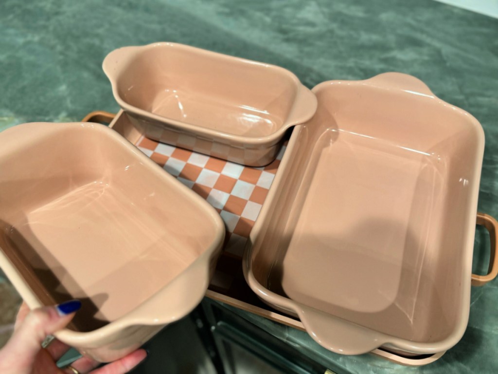 Pink our place bakeware set on green countertop