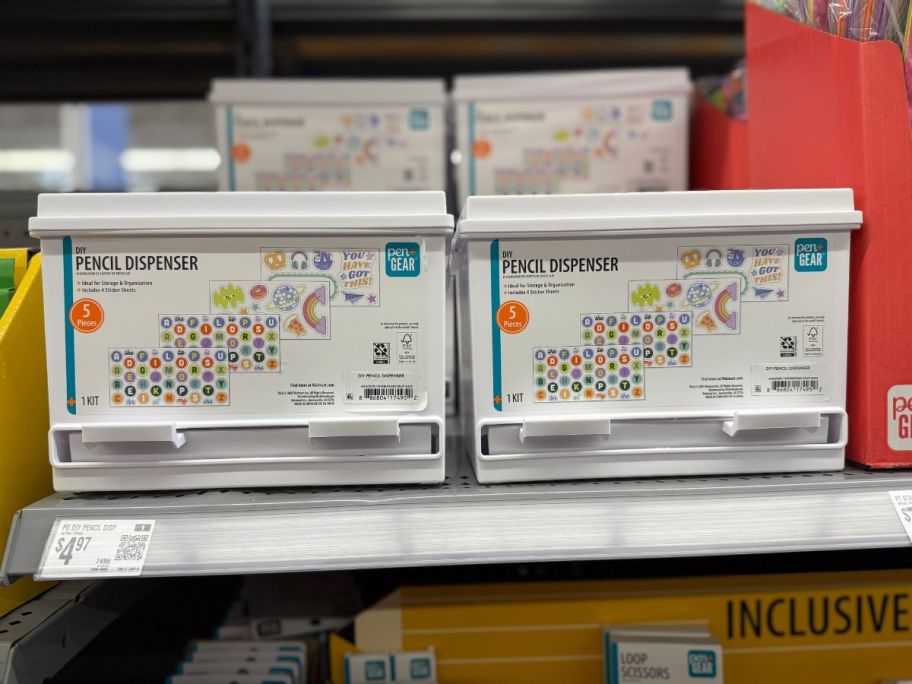 2 white boxes containing pencil dispensers in the them displayed in a store