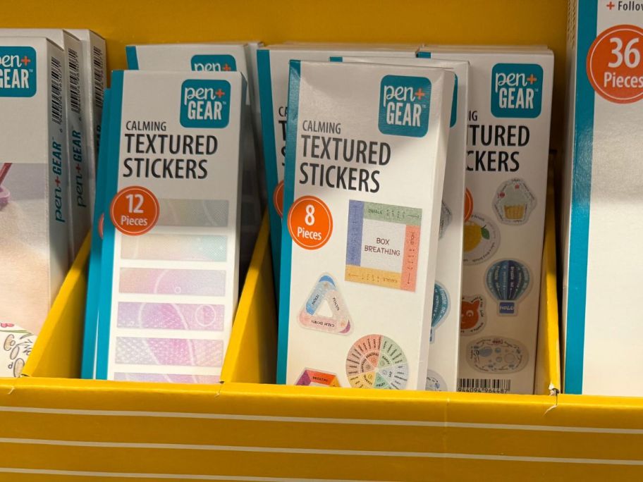 White boxes of textured stickers in a store display