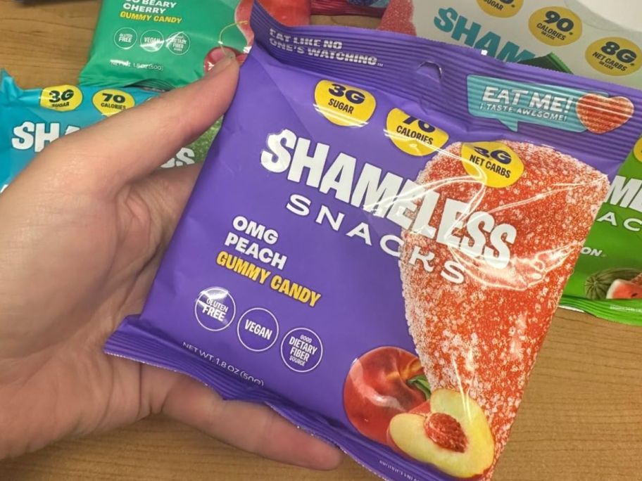 hand holding shameless peach ring snacks